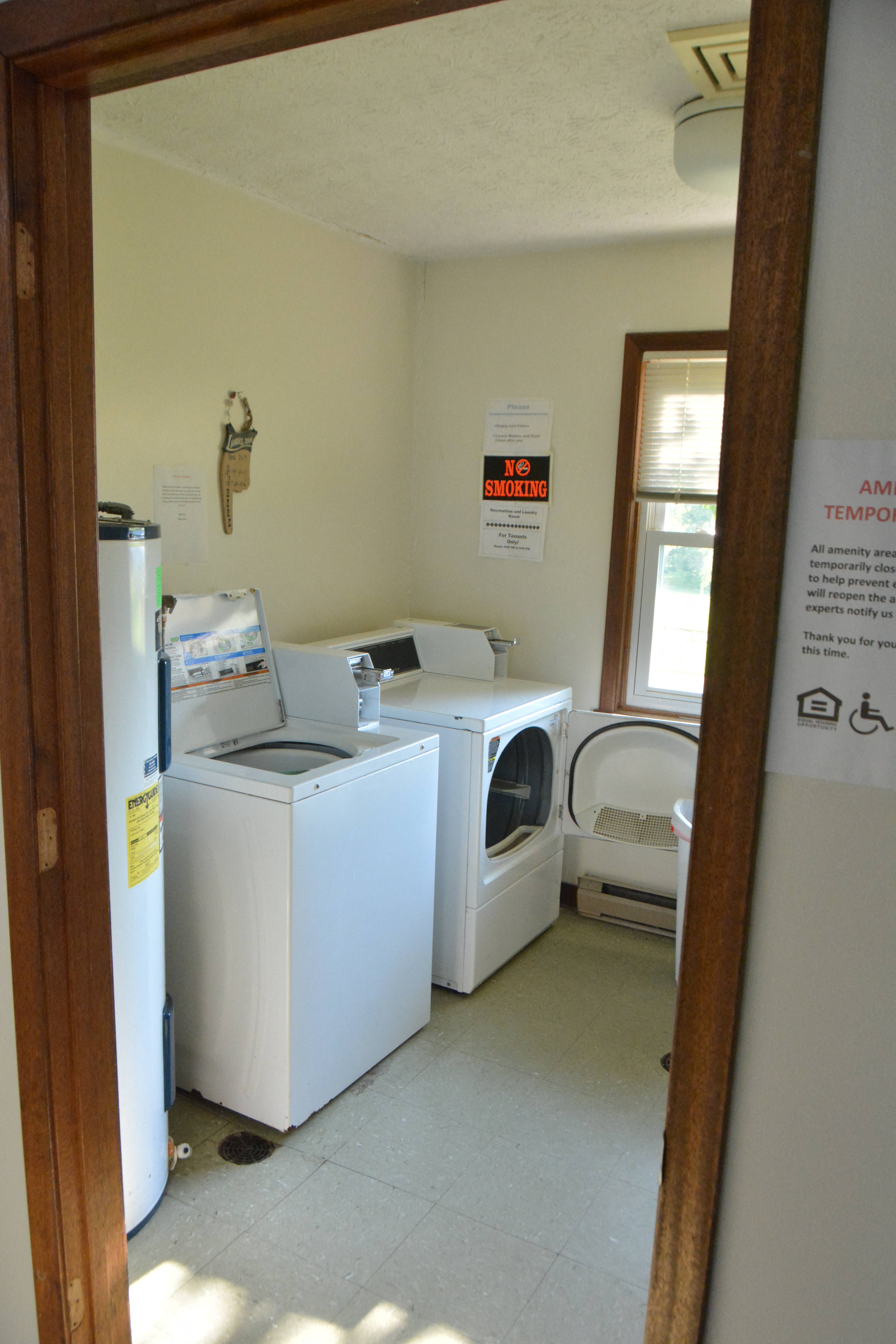 a laundry room with two washing machines and a refrigerator
